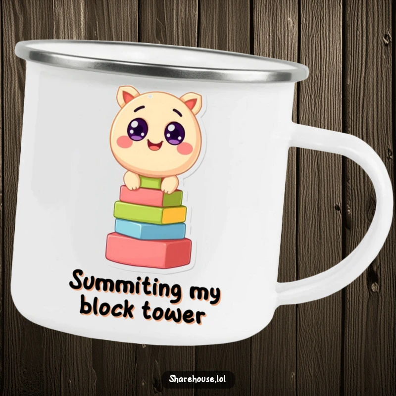 Funny camping mug displaying a cheerful round creature with wide eyes, stacking colorful blocks, ready for outdoor enjoyment.