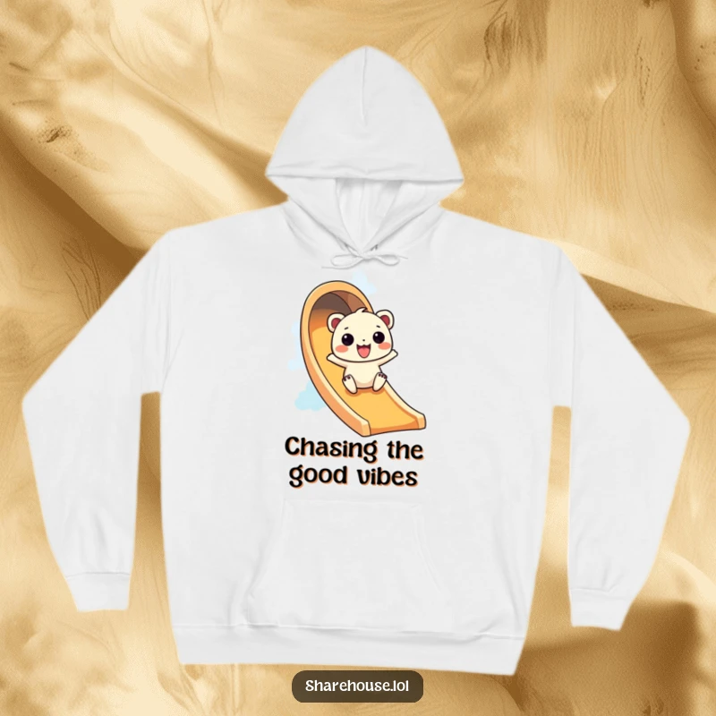 Funny hoodie with a wiggly creature gleefully sliding down a bright rainbow slide, offering cozy fun.